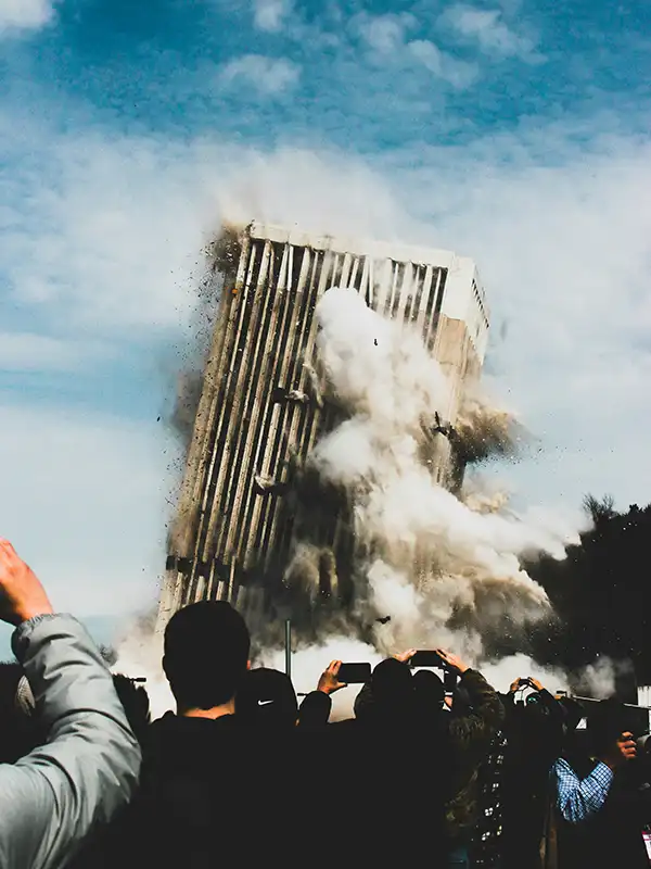 Building demolition with crowd watching nearbyRetry