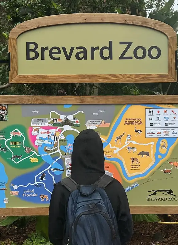 Person viewing Brevard Zoo map sign