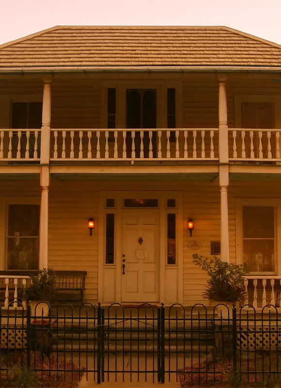 Two-story wooden house with front balcony