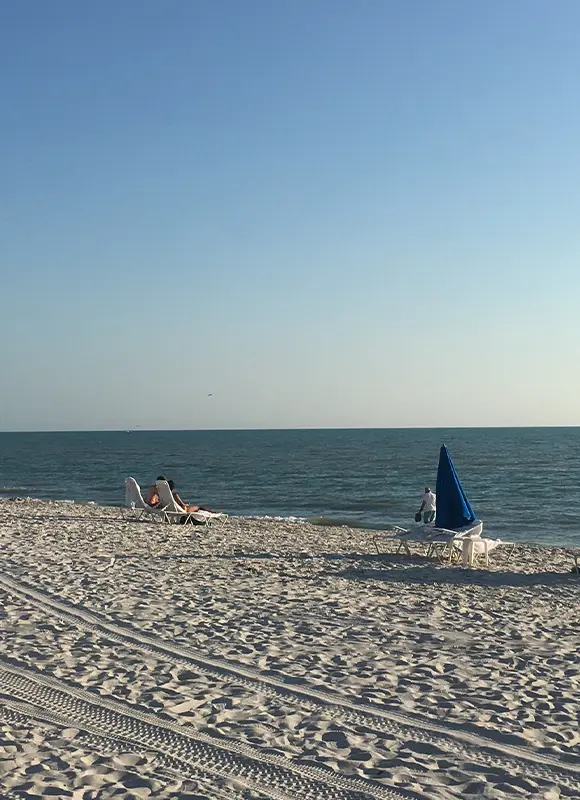 Person relaxing on quiet sandy beach
