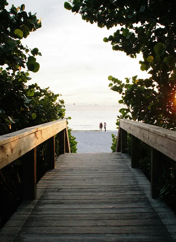 Wooden boardwalk leading to sunny beach
