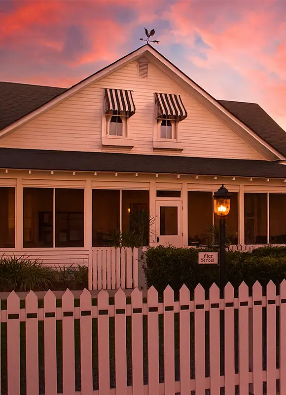 Charming house with striped awnings twilight