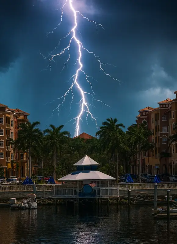 Lightning strike over waterfront residential marina