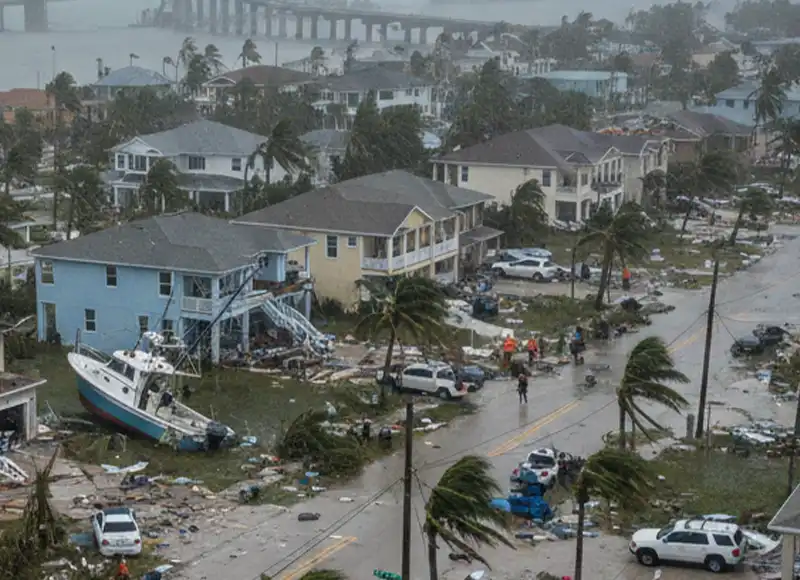 Storm-beached yacht lodged against hurricane-devastated Fort Myers Florida neighborhood