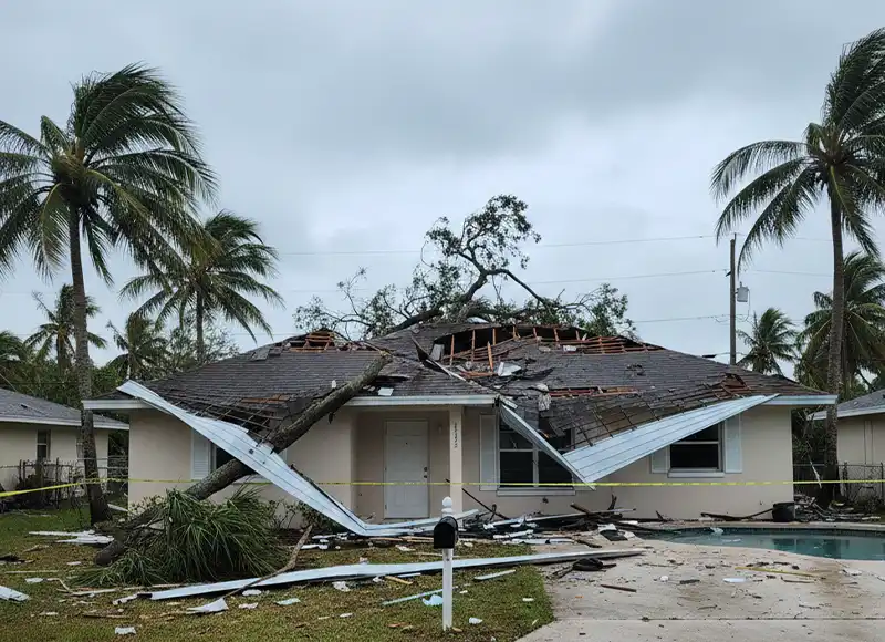 Hurricane-toppled tree crushing collapsed roof of Florida pool home