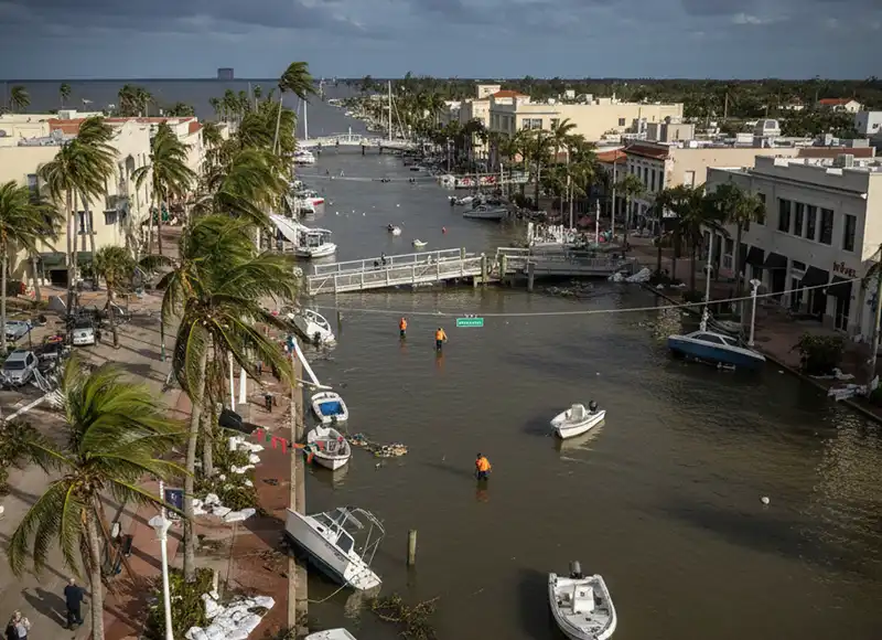 Hurricane Ian floodwaters submerging downtown Fort Myers streets with displaced boats
