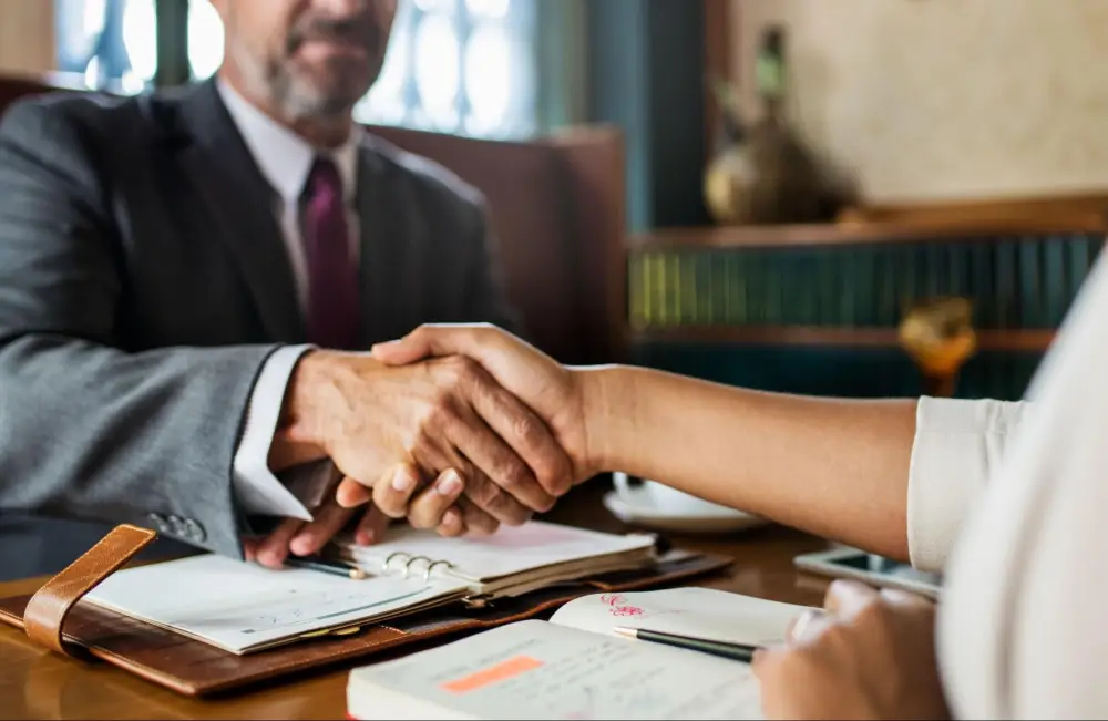 Business handshake meeting before reviewing boutique property damage firms